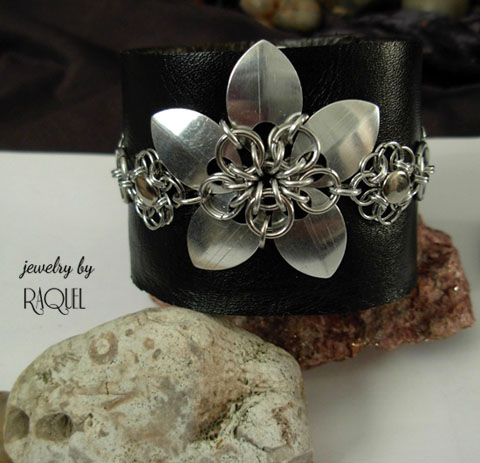 Black leather Rock N' Roll wrist band cuff with Flower scales